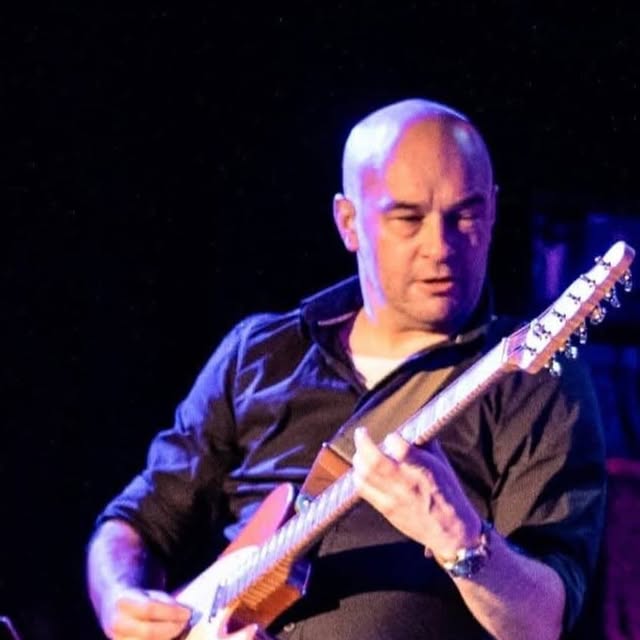 Tom Warham playing guitar